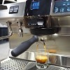 This image is a closeup view of the Rancilio Specialty RS1 espresso machine in Stainless Steel, with adjustable drip tray for varied brew group height and volumetric dosing controls.